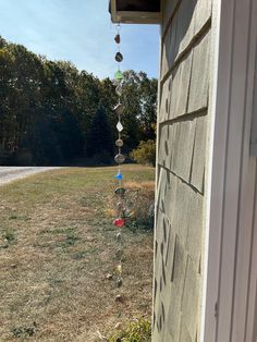 an outside view of a house with some glass beads hanging from the side of it