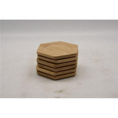 four wooden coasters stacked on top of each other in the shape of hexagons