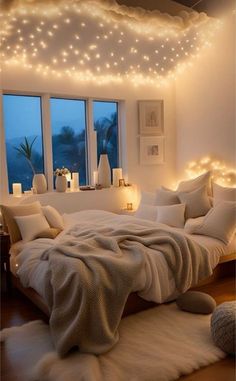 a bedroom with lights on the ceiling and a bed in front of a large window