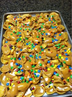 a tray filled with lots of chocolate covered pretzels and sprinkles