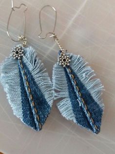 two pairs of blue and white earrings on a table