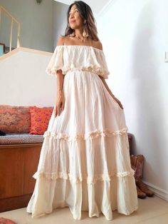 Bohemian off shoulder wedding dress . Double Ruffle and unfinished hem. Elastic neckline and waist. Can be worn as cover or off shoulders and one side shoulders. 100% cotton with lined. 2 pockets in the front. Color Off White. Measurements: The model is 5'5 Bust 30 up to 42 inches. Hip Free. Length 56 inches. CARE: Machine wash cold. Off-shoulder Cream Wedding Dress, Bohemian Tiered Wedding Maxi Dress, Bohemian Tiered Maxi Dress For Wedding, Bohemian Tiered Cream Maxi Dress, Bohemian Cream Tiered Maxi Dress, Bohemian Beige Tiered Maxi Dress, Bohemian Strapless Dresses With Ruffles, Off-shoulder Ruffled Maxi Dress For Wedding, White Bohemian Off-shoulder Maxi Dress