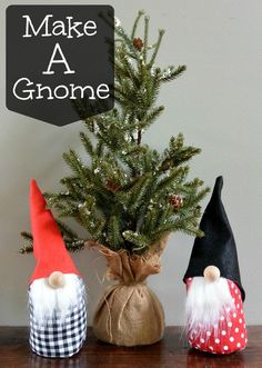 three gnomes sitting next to each other near a christmas tree in a bag on a table