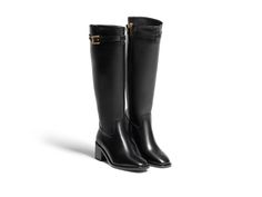 The Maya Rider is the epitome of equestrian inspired elegance, designed with a sleek and modern silhouette that effortlessly commands attention. This fashion-forward riding boot features an inside zipper for easy wear, while the ornamental strap adorned with a gold "M" adds a chic touch. Elegant Knee-high Riding Boots, Elegant Boots With Horsebit Detail For Work, Elegant Leather Riding Boots, Elegant Leather Boots With Horsebit Detail, Chic Formal Boots With Horsebit Detail, Elegant Knee-high Boots, Elegant Knee-high Boots For Work, Elegant Business Calf Leather Knee-high Boots, Elegant Black Riding Boots