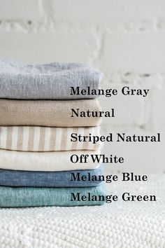 folded linens stacked on top of each other with the words melange gray natural striped natural