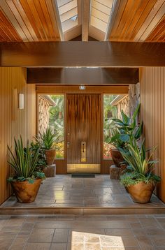 an entry way with potted plants on either side