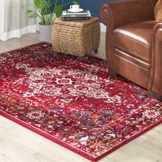 a living room with a brown chair and red rug