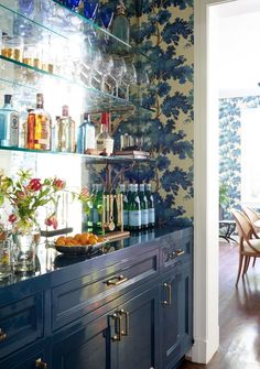 a kitchen with blue cabinets and floral wallpaper on the walls is pictured in this image