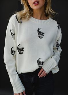 Cream knit sweater Black skull designs on the front and back Long sleeves Relaxed fit Imported garment 100% Acrylic SIZE CHARTS: Bust: 40" / Length: 22"M: Bust: 42" / Length: 23"L: Bust: 44" / Length: 24"XL: Bust 46" / Length: 25" Horse Sweater, Skull Designs, Fall Sweaters For Women, Brown Knit Sweater, Skull Sweater, Cream Knit Sweater, Halloween Sweater, Cozy Knit Sweater, Black Skull