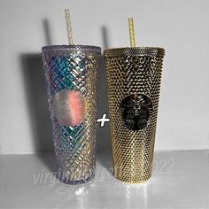 two different colored glass cups with straws in them on a white counter top next to each other