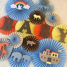 several paper fans with animals and boats on them