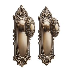 two antique style door knobs with ornate designs