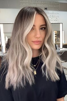 Are you looking for a new hair color? If you want something trendy and eye-catching, ash blonde might be your best choice.… Fall Blonde Hair Color Cool Tones, Root Melt Ash Blonde, Ash Blonde Hair Dark Roots, Undone Blonde Hair, Trendy Fall Hair Color For Blondes, Light Ashy Blonde Hair, Ashy Hair Color, Tone Blonde Hair