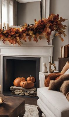 a living room filled with furniture and a fire place covered in fall leaves on top of a mantle