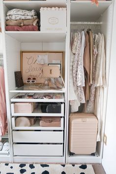 an organized closet with clothes and suitcases