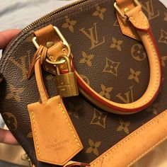 Alma Bb Monogram Is In Good Condition. It Comes With A Strap And Dust Bag. Alma Bb Monogram, Lv Alma Bb Damier, Luxury Tan Monogram Print Shoulder Bag, Bb Monogram, Designer Brown Monogram Bag, Brown Monogram Shoulder Bag, Alma Bb, Luxury Brown Monogram Print Bag, Louis Vuitton Bags