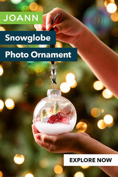 someone is holding up a snow globe ornament