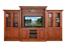 an entertainment center with wooden cabinets and a flat screen tv mounted on it's wall