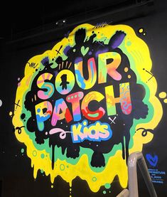 a large mural on the side of a building that says sour patch kids