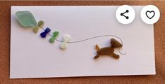 a card that has been made to look like a dog on a string with hearts