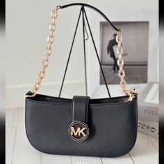 Michael Kors Carmen Small Pouchette Chain Shoulder Bag Black Vegan Leather Gold Shoulder Bag Faux Leather 88.92% Coated Canvas/11.08% Polyester Trim: 60% Polyurethane/20% Cotton/20% Polyester Gold-Tone Hardware 9.5”W X 5”H X 3”D Handle Drop: 14” Interior Details: 3 Front Credit Card Pockets Lining: 100% Polyester Snap Fastening Formal Black Shoulder Bag With Metal Logo, Chic Black Shoulder Bag With Metal Logo, Chic Office Shoulder Bag With Metal Logo, Black Bags With Metal Logo For Everyday Use, Trendy Shoulder Bag With Metal Logo For Everyday, Trendy Michael Kors Bag With Chain Strap, Elegant Shoulder Bag With Metal Logo For Shopping, Everyday Michael Kors Shoulder Bag With Chain Strap, Trendy Michael Kors Shoulder Bag With Gold-tone Hardware