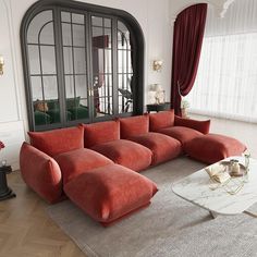 a living room with red couches and windows