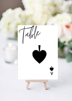 a card with a heart on it sitting on a table