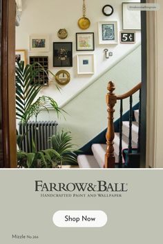 a staircase with pictures on the wall above it and an advertisement for farrow & ball's handcrafted paint and wallpaper