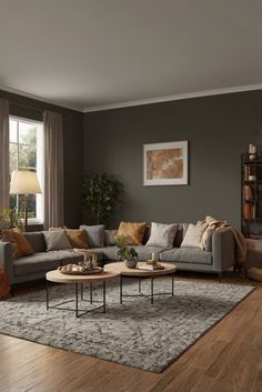 a living room filled with furniture and a large rug on top of a hard wood floor