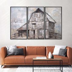 a living room with two paintings on the wall and a couch in front of it