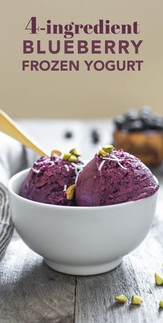 two scoops of blueberry ice cream in a white bowl