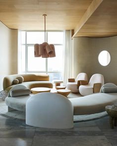 a living room filled with furniture next to a window