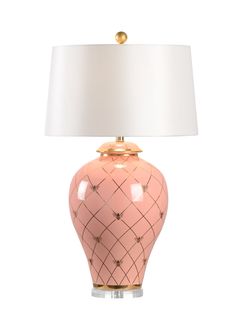 a pink and gold table lamp with a white shade on the top, sitting against a white background