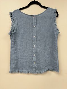 Elevate your wardrobe with our Italian Linen Distressed Hem Tank Top! Made with premium linen, it offers a comfortable and loose fit, perfect for any body size (s-l). The buttoned back, scoop neckline and distressed hem add a touch of style to this basic, versatile piece. Easy to wear, easy to love! Casual Light Wash Linen Tops, Summer Linen Tops With Frayed Hem, Summer Linen Tops With Scoop Neck, Light Wash Linen Tops For Summer, Summer Linen Top With Scoop Neck, Summer Light Wash Linen Tops, Sleeveless Medium Wash Tops For Beach, Scoop Neck Linen Top For Summer, Chic Light Wash Top With Frayed Hem