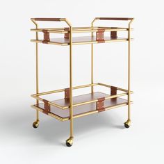 a gold and brown bar cart with two shelves on wheels, one shelf is empty