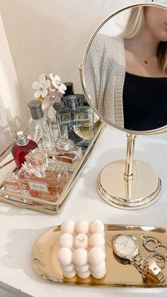 a woman taking a selfie in front of a mirror with makeup on the counter