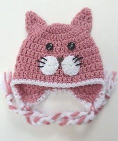 a pink crocheted cat hat with ears