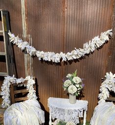 two chairs and a table with flowers on them