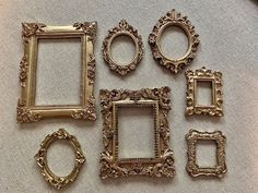 there are many gold frames on the table