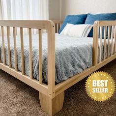 a wooden bed frame sitting on top of a carpeted floor next to a window