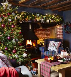 a living room decorated for christmas with a large tree