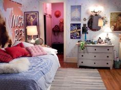 a bedroom decorated in pink, blue and white