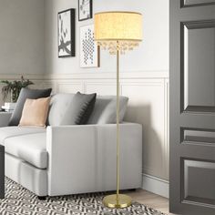 a living room scene with focus on the floor lamp and sofa in the background,