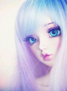 a close up of a doll with blue eyes