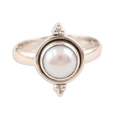 The luminous purity of a cultured white pearl takes center stage on this sterling silver ring from India's Rakesh Rana. The pearl is set on a simple band with a bead-accented bezel. Classic Sterling Silver Pearl Drop Ring, Stackable Round Pearl Ring, Adjustable Pearl Ring For Formal Occasions, Adjustable Formal Pearl Ring, Sterling Silver Pearl Ring With Pearl Drop, Classic Adjustable Pearl Ring, Adjustable Pearl Drop Round Rings, Adjustable Classic Pearl Ring, Classic Pearl Ring With Bezel Setting