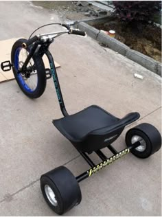 an electric scooter is parked on the concrete near a skateboard and ramp