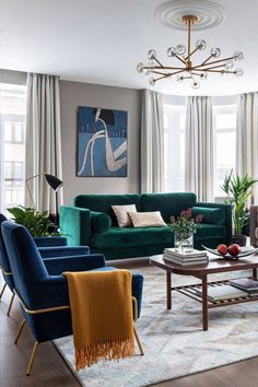 a living room filled with furniture and a chandelier