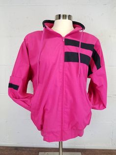 Vintage 1980s Westside Connections Hot Pink and Black Colorblock Windbreaker Jacket size small.  Zip front light weight poly cotton windbreaker.  Black and hot pink colorblock.  Two side pockets and one sleeve pocket.  Zip up collar with a drawstring.  Very Good vintage condition.  Shoulder pads.  No rips, holes or noticeable stains.  One or two very light spots that don't show in photos. Tagged size small. Please refer to measurements provided to determine proper as vintage sizes can vary great Westside Connection, Colorblock Windbreaker, Black And Hot Pink, Muumuu Dress, 80s Denim, Boho Jeans, Prairie Skirt, Hot Pink And Black, Light Spots