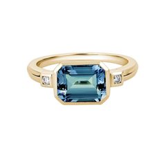 This ring features an emerald-cut London blue topaz center flanked by a diamond accent set on either shoulder in 14K yellow gold. Total diamond weight: 0.05 ct Ring size: 7.25 Blue Topaz Jewelry, Lavender Quartz, Colored Stone Rings, Diamond Accent Ring, Emerald Cut Rings, Topaz Engagement Ring, Topaz Jewelry, London Blue Topaz Ring, Swiss Blue Topaz