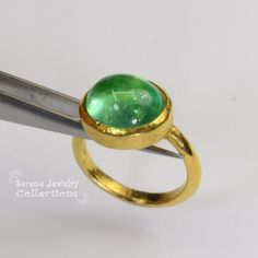 This designer J.Hengen ring features a glowing green beryl cabochon set in 18k solid gold. Ring Size: 6.75 Total Weight: 11.78 grams Precious Metal: 18k solid gold Precious stones: -Green Beryl Center Stone: 12 carats, 15mm x 13mm Hallmark: J Green Cabochon Dome Ring For Formal Occasions, Modern Round Cabochon Emerald Ring, Luxury Green Domed Ring, Modern Yellow Gold Emerald Cabochon Ring, Gold Emerald Cabochon Ring For May Birthstone, Estate Ring, Estate Rings, Platinum Diamond Rings, Solid Gold Ring